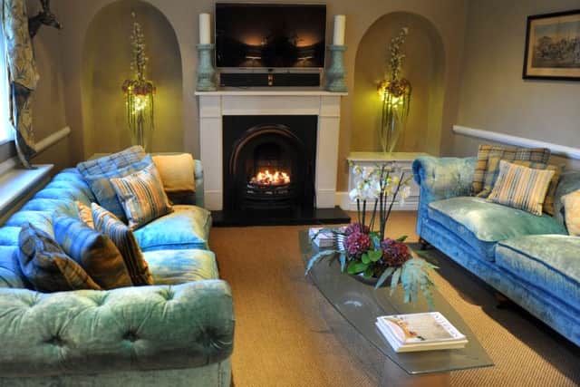 The chesterfields were upholstered in turquoise by Geoffrey Benson