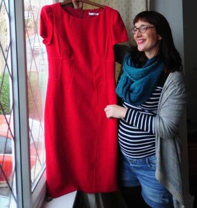 Sally Hall with a red dress picked up from a charity shop after she landed a new job. Picture by Simon Hulme.