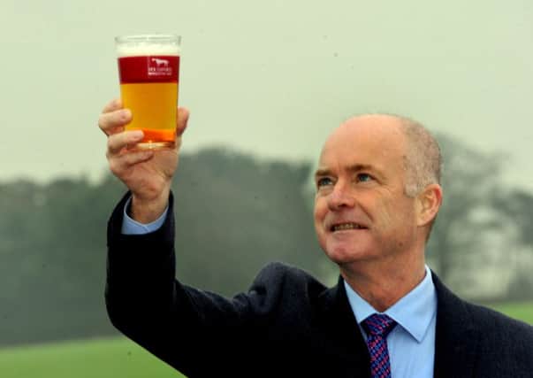 Nick Stafford holds aloft a pint of nectar.  Pictures: Gary Longbottom