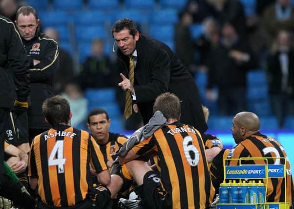 Hull City manager Phil Brown gives his infamous team talk on the pitch during half-time in the match against Manchester City on Boxing Day 2008 (Picture: PA).
