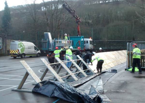 Temporary flood defences being put up at Riverside School in Hebden Bridge, as Britain braces itself for the arrival of Storm Barbara. PRESS ASSOCIATION Photo.