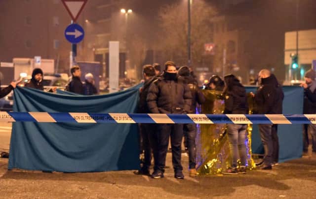 Italian police cordon off an area around a body after a shootout between police and a man in Milan's Sesto San Giovanni neighborhood