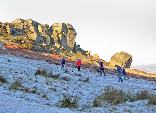 29 December 2016.......  A family makes their way past the Cow and Calf in Ilkley as a sharp frost hit the region. Picture Tony Johnson.