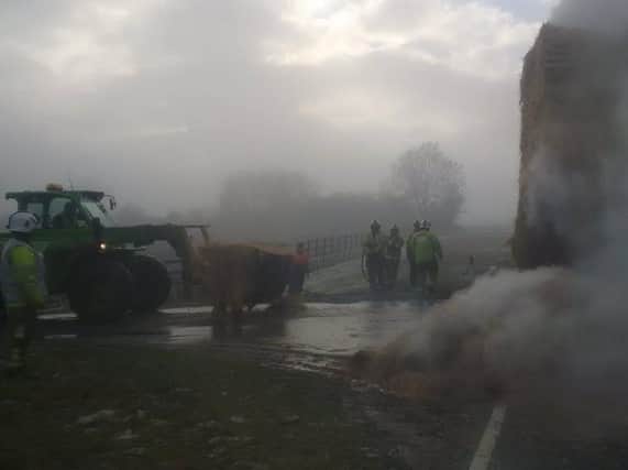 Firefighters dealing with the burning straw by the side of the A1. (Photo: North Yorkshire Police)