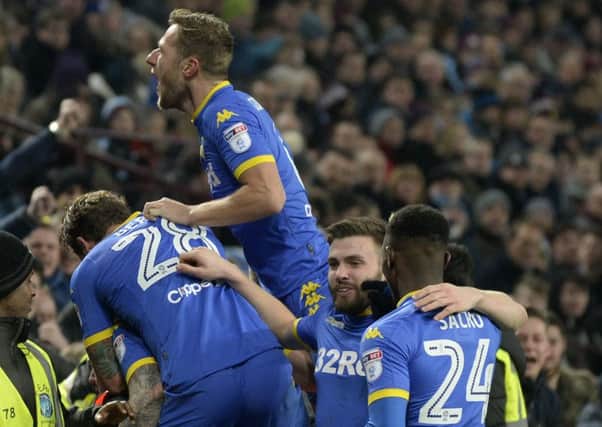 Pontus Jansson is submerged beneath exultant team-mates after giving Leeds United the lead against Aston Villa (Picture: Bruce Rollinson).