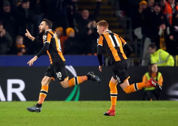 Robert Snodgrass wheels away with team-mate Sam Clucas in pursuit after putting Hull City 2-1 ahead against Everton with a stunning free-kick (Picture: Danny Lawson/PA Wire).