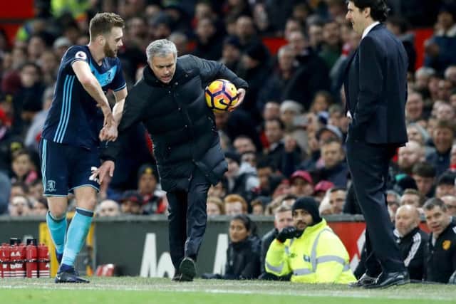 Jose Mourinho keeps the ball away from Boro defender Ben Gibson, as Aitor Karanka watches on with a smile on his face (Photo: PA)