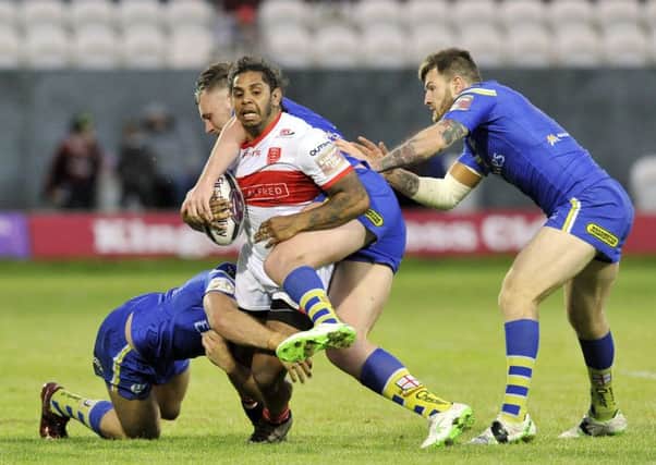 CROSSING THE DIVIDE: Albert Kelly, seen being held by the Warrington defence, has made the cross-city switch from relegated Hull Kingston Rovers to Challenge Cup winners Hull FC. Picture: Bruce Rollinson