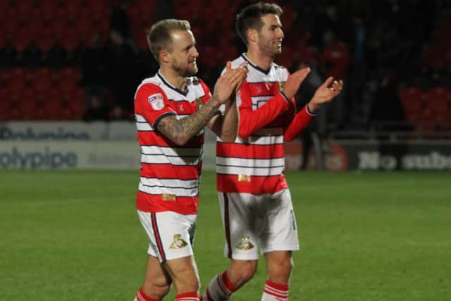 James Coppinger and Matty Blair applaud the Doncaster fans at full-time after their 1-0 win over Stevenage.  (Picture: Simon Hall)