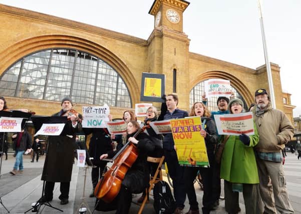Members of the Fair Fares Now passenger campaign group protesting at King's Cross Station in London over the annual rise in rail fares after the average increase across Britain of 2.3 per cent came into force on Monday.
