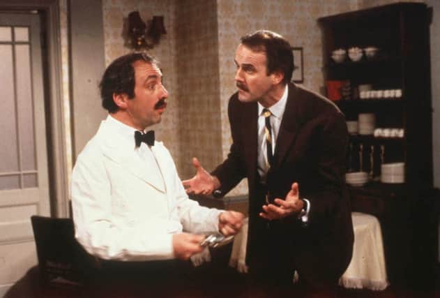 Andrew Sachs as Manuel and John Cleese as Basil in BBC's Fawlty Towers.