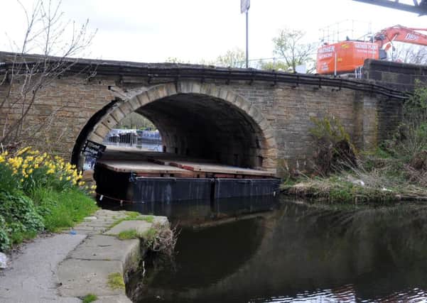 Elland Bridge as it looked in April when engineers started removing stonework as part of work to dismantle it.
