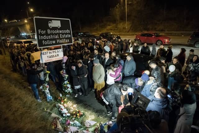 Mourning friends and family hold a vigil at Jct 24 of the M62.