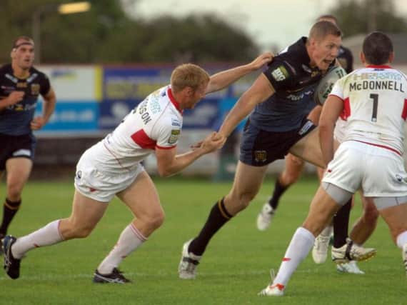 David Hodgson, left, attempts to make a tackle for Hull KR