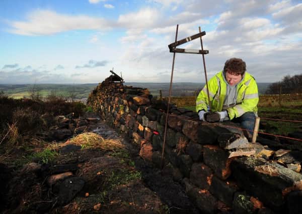 Dry stone waller Thomas Page at work on Otley Chevin.  PIC: Simon Hulme