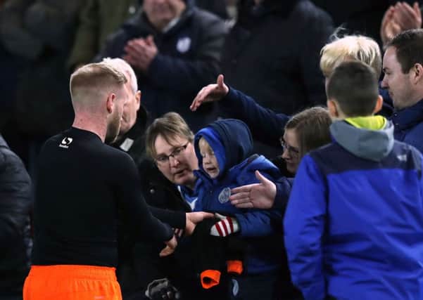 Sheffield Wednesday's Barry Bannan gives his shirt to a young fan after the game.