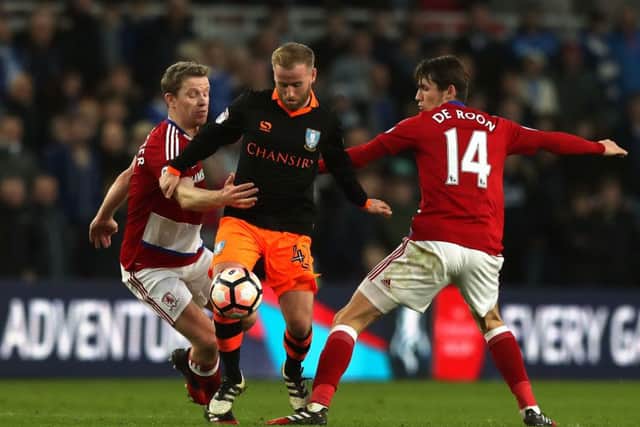 Sheffield Wednesday's Barry Bannan (centre) battles for the ball with Middlesbrough's Marten de Roon and Grant Leadbitter (left).