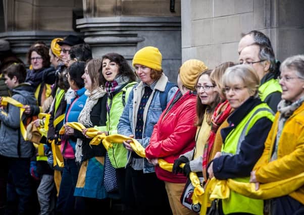Campaigners form a human chain around Sheffield Town Hall as a protest against Sheffield Council chopping down trees in the city