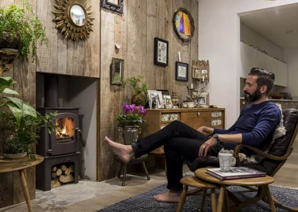 Oliver Heath in his healthy and happy sitting room with timber wall