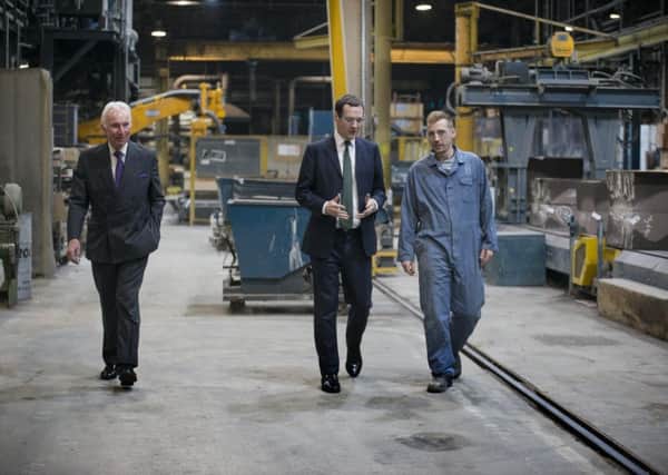 Sir Andrew Cook, left, accompanies George Osborne during a tour of his facotry in Leeds.