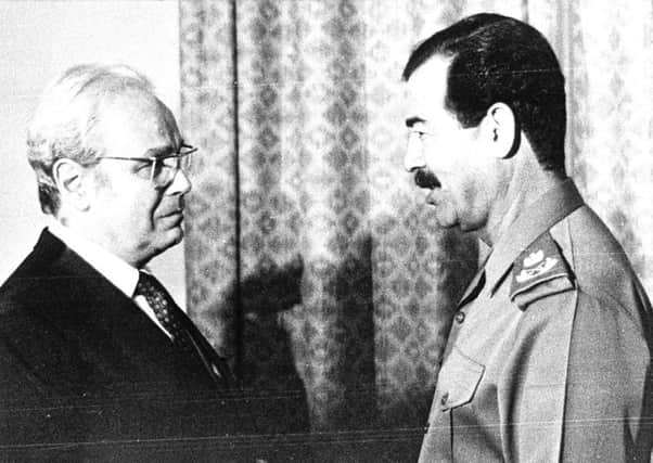 Then United Nations Secretery General Javier Perez de Cuellar, left, shakes hands with Iraqi President Saddam Hussein in Baghdad, Iraq, in this Sept. 14, 1987 file photo.  (AP Photo/File)