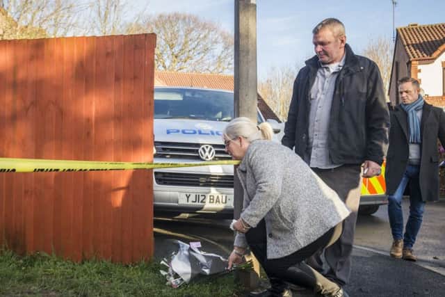The grandparents of the victim leave a floral tribute near Alness Drive in the Woodthorpe area of York