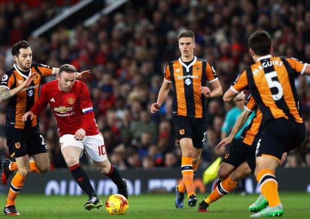 Wayne Rooney tries to find a way through the Hull City defence at Old Trafford on Tuesday night. Picture: PA.