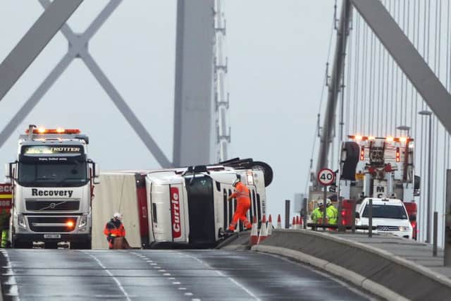 An overturned lorry on the Forth Road Bridge near Edinburgh, as high winds brought travel chaos and power cuts