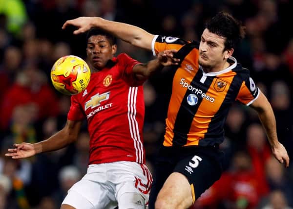 Harry Maguire, right, challenges Manchester Uniteds Marcus Rashford for the ball on a night when Hull City lost control of the semi-final tie. (Picture: PA)