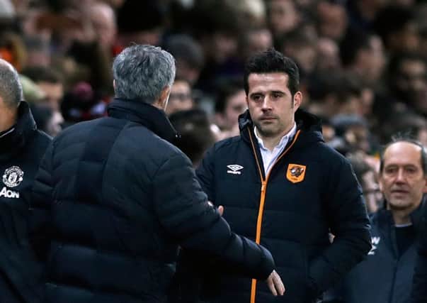 PLEASED TO MEET YOU: Hull City manager Marco Silva, right, is greeted by Manchester United counterpart, Jose Mourinho at Old trafford on Tuesday night. Picture : Martin Rickett/PA