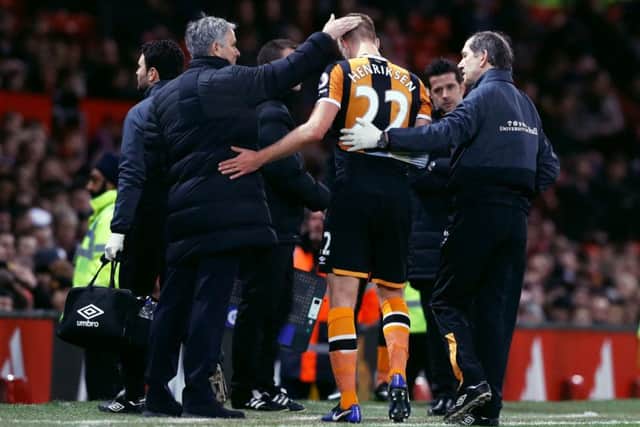 INJURY PILE-UP: Hull City's Markus Henriksen is consoled by Manchester United manager Jose Mourinho (left) after being substituted  at Old Trafford on Tuesday night. Picture: Martin Rickett/PA
