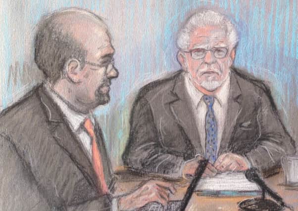 Court sketch by Elizabeth Cook of Rolf Harris appearing by video link at Southwark Crown Court in London, where he is accused of seven counts of indecent assault and one of sexual assault.