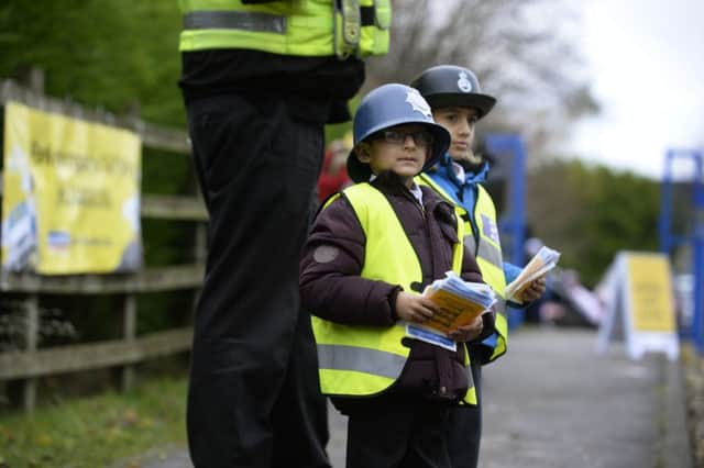 Pupils on patrol as traffic wardens outside a Bradford school in a bid to halt irresponsible parking.