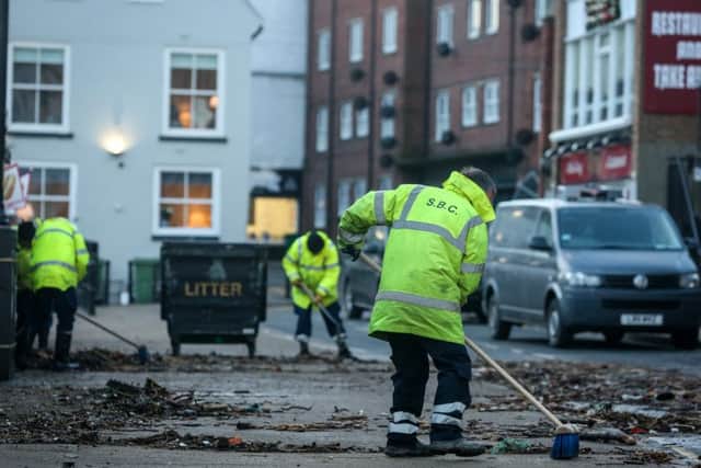 Council workers begin clearing up Pier Road.