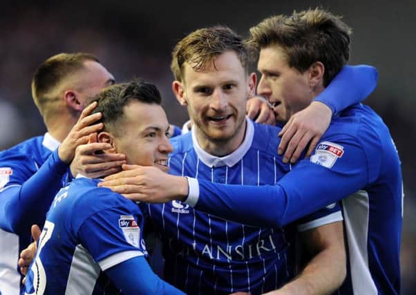 Tom Lees, centre, congratulates Ross Wallace on his goal which opened the scoring against Huddersfield Town on Saturday. Picture: Steve Ellis.