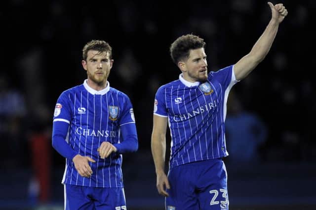 GOOD START: Debuant Sam Winnall, celebrates the Owls victory over Huddersfield with new team-mate, Sam Hutchinson . Picture: Steve Ellis