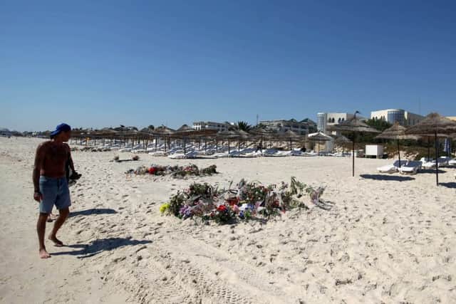 Flowers on the beach near the RIU Imperial Marhaba hotel in Sousse, Tunisia, the scene of the massacre. Inquests into the deaths of the 30 Britons killed will begin today. Pic: Steve Parsons/PA Wire