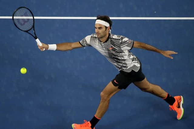 Switzerland's Roger Federer makes a forehand return to Austria's Jurgen Melzer during their first round match at the Australian Open in Melbourne. Picture: AP/Dita Alangkara.