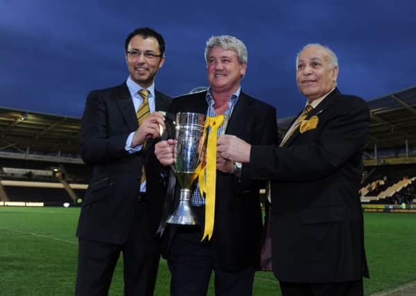 HAPPIER TIMES: Ehab Allam, left and Dr Assem Allam, right, pose with the 2013 Championship runners-up trophy alongside former manager Steve Bruce.