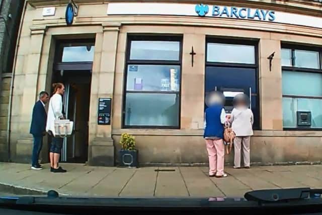 A police camera image showing Ilie and an unknown male outside a bank in Bedale.
