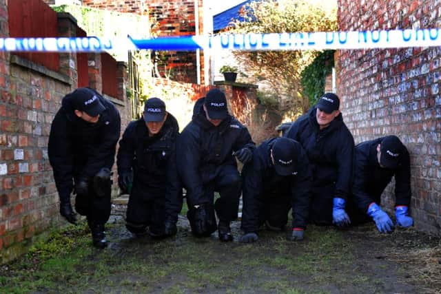 25/2/15 North Yorkshire Police Officers search an alleyway near to Claudia Lawrence's home in York.