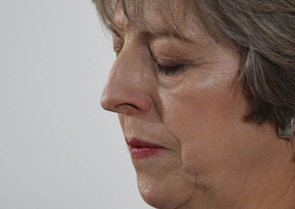 Theresa May pauses for thought during her speech today