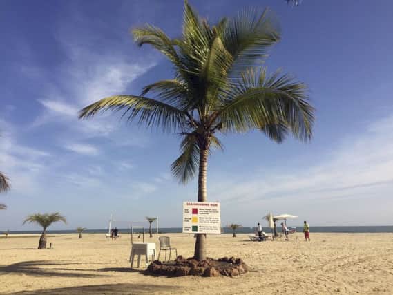 Tourists lay on the beach in Gambia's capital Banjul