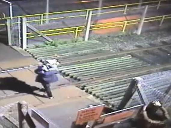 CCTV shows the adults climbing over a six-foot-high locked gate at Seamer station in North Yorkshire.