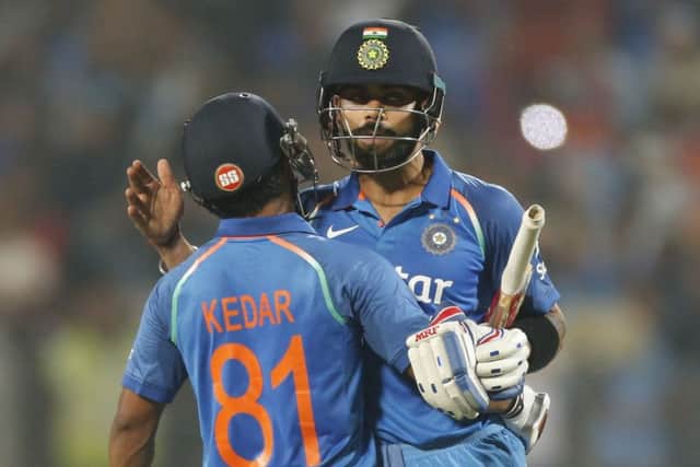 India captain Virat Kohli celebrates wreaching a century against England in Pune on Sunday. Picture: AP/Rajanish Kakade