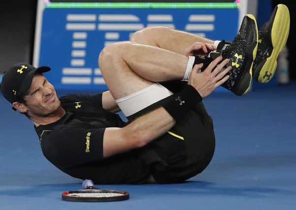 Britain's Andy Murray reacts as he falls during his second round match against Russia's Andrey Rublev. Picture: AP/Dita Alangkara.