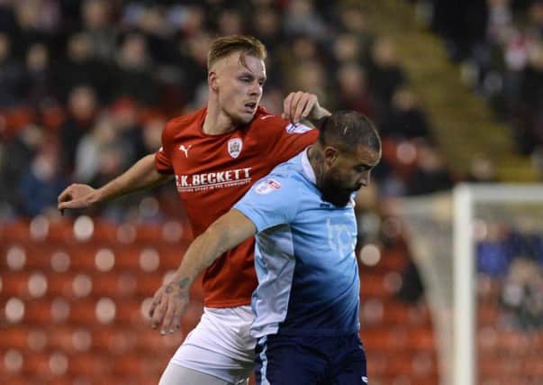 Barnsley's Marc Roberts is held off the ball by Blackpool's Kyle Vassell in the FA Cup replay
Picture Bruce Rollinson