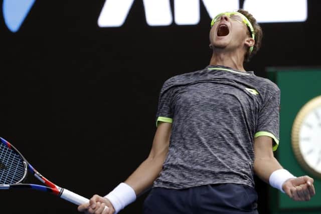 Uzbekistan's Denis Istomin celebrates his win over Serbia's Novak Djokovic at the Australian Open. Picture: AP/Aaron Favila.