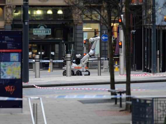 An army bomb disposal robot deals with the suspect package