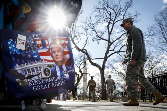 Military personnel walk along the National Mall in Washington